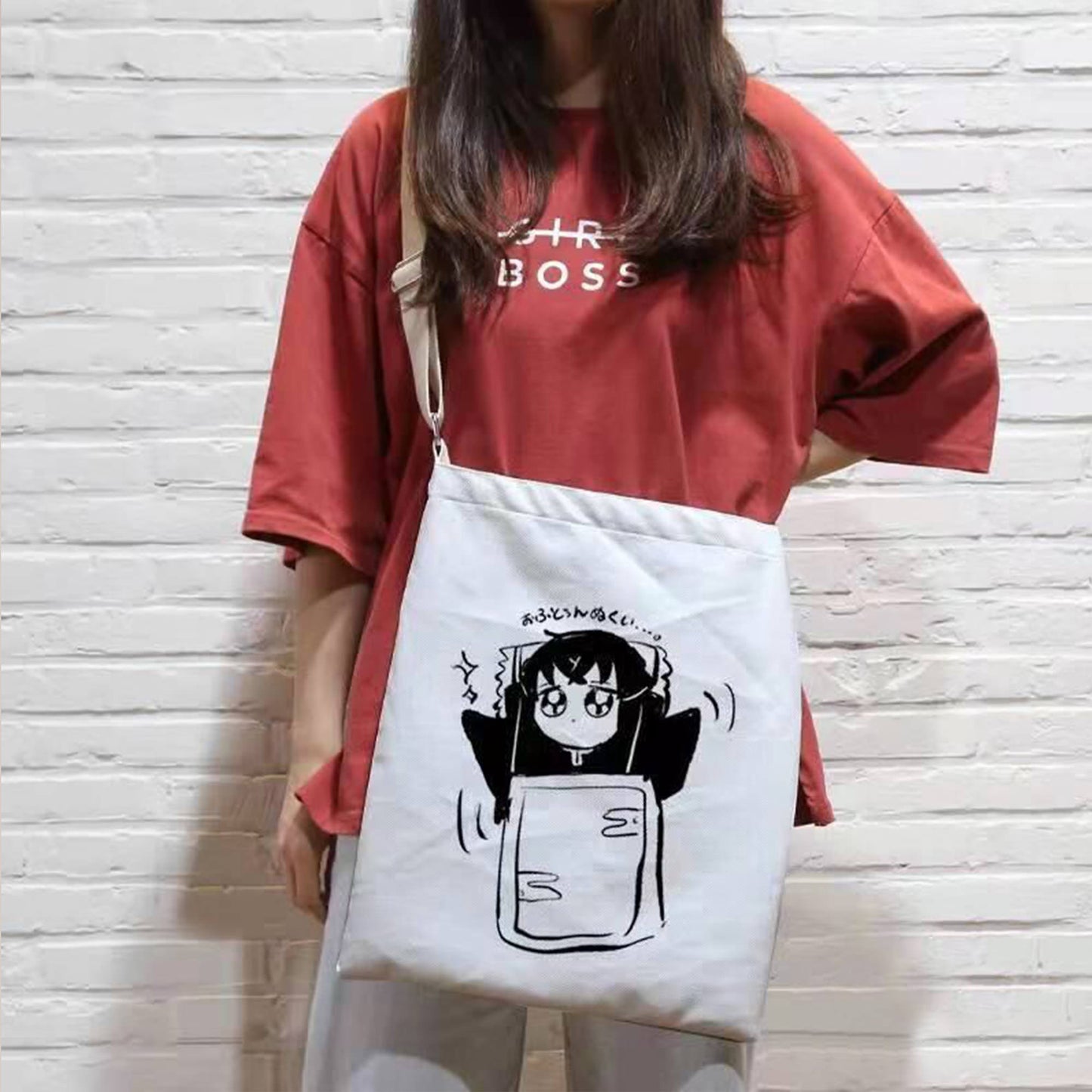 A beige crossbody bag with a personalized photo of a girl's favorite cartoon role. The bag has a long strap that is worn over the shoulder. The bag is made of quality, textured material and has a simple, yet elegant design.